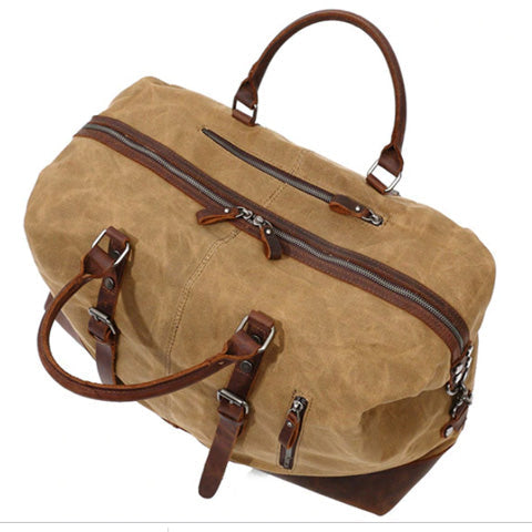 Detail view of the duffle bag hardware, zipper, and strap attachment