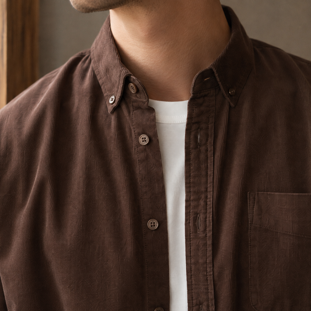 Close-up of the textured fabric and button-down collar on a men's overshirt