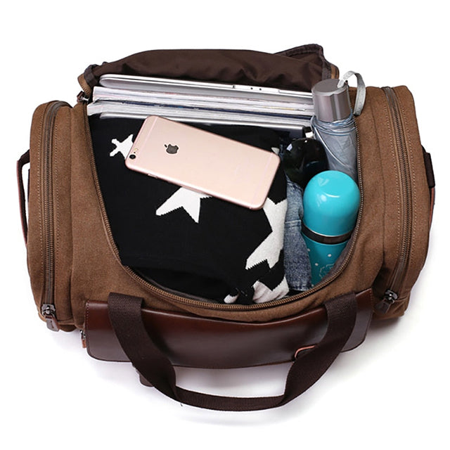 Close-up of leather trim and canvas material on large travel work bag