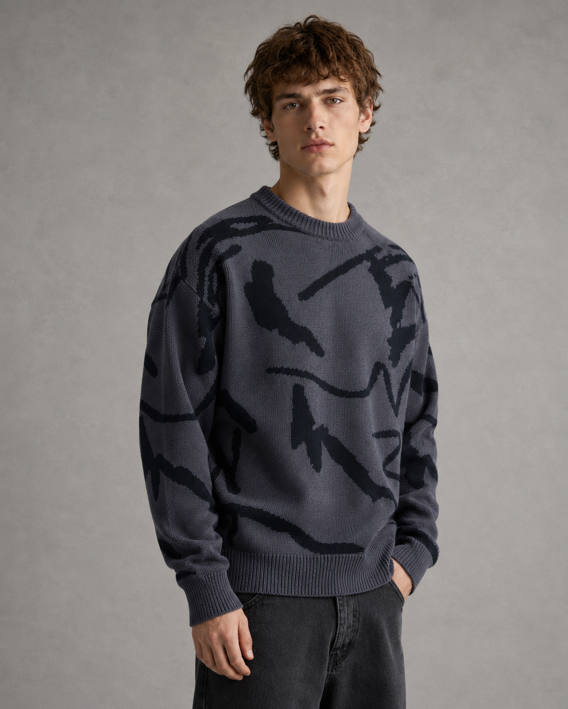 Men's knit sweater showing the relaxed neckline and long sleeves.