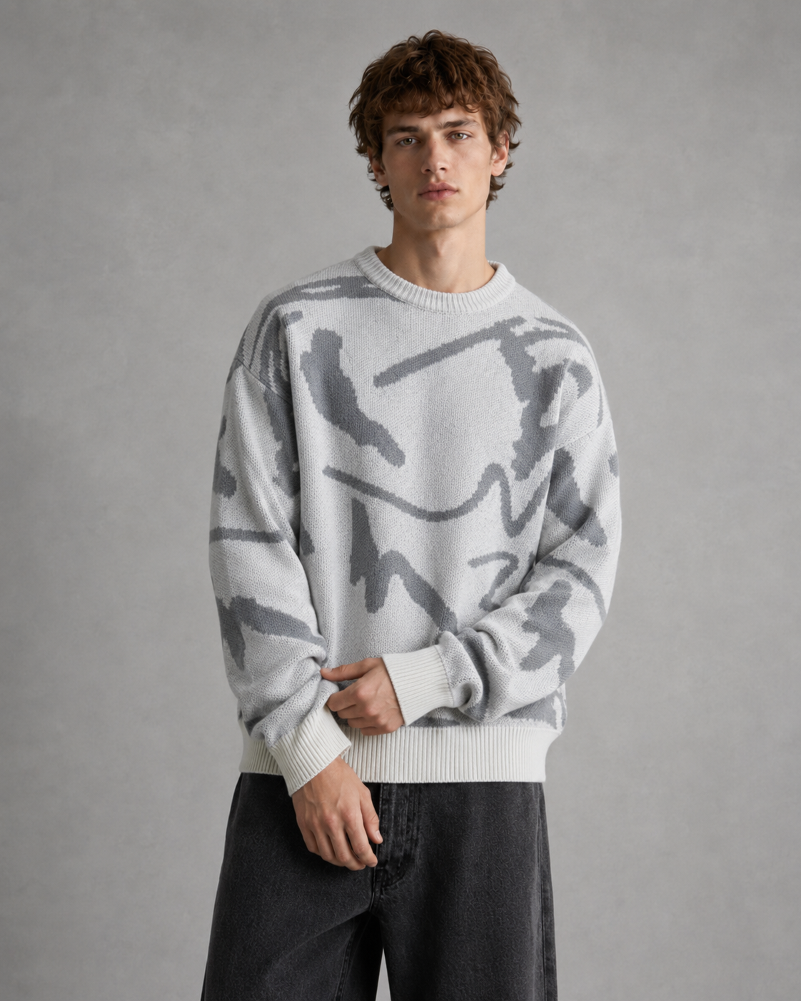 Men's abstract graphic knit sweater styled as a casual everyday layer.