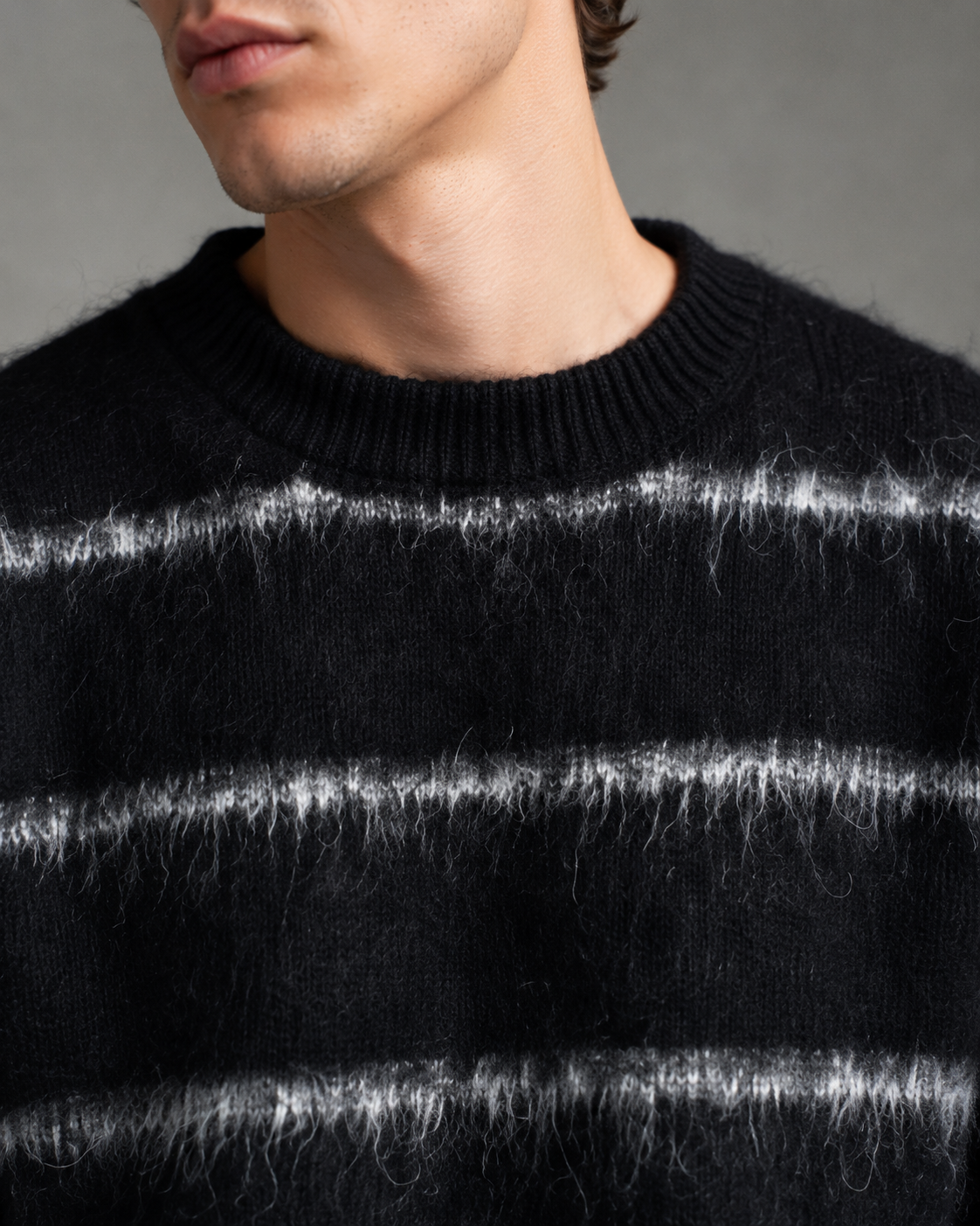 Men's striped knit sweater styled as a casual streetwear layer