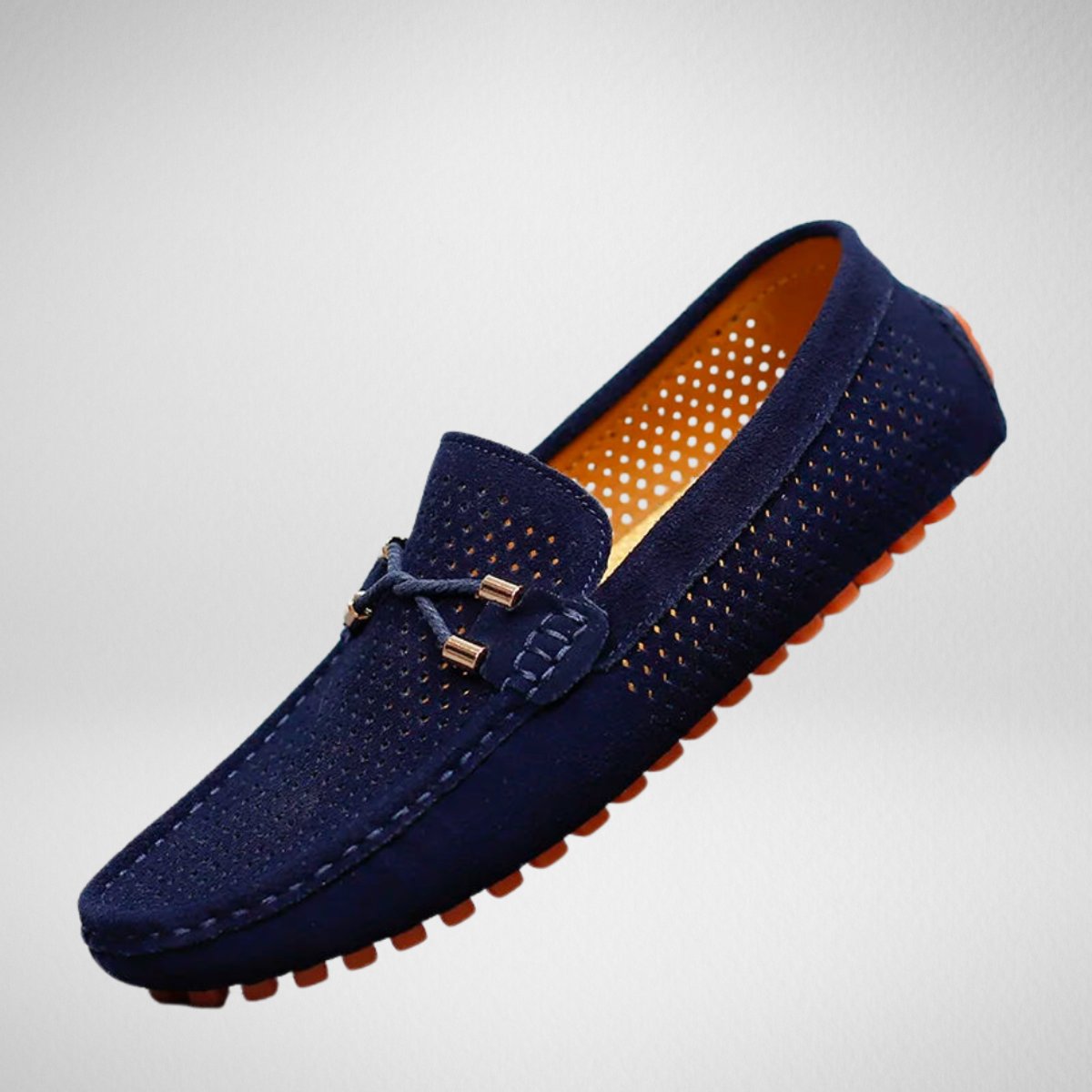 Pair of men's perforated suede slip-on driving loafers shown from the side