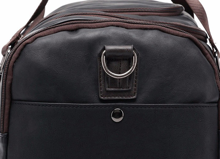Open men's leather duffel bag showing spacious main compartment for work and weekend packing