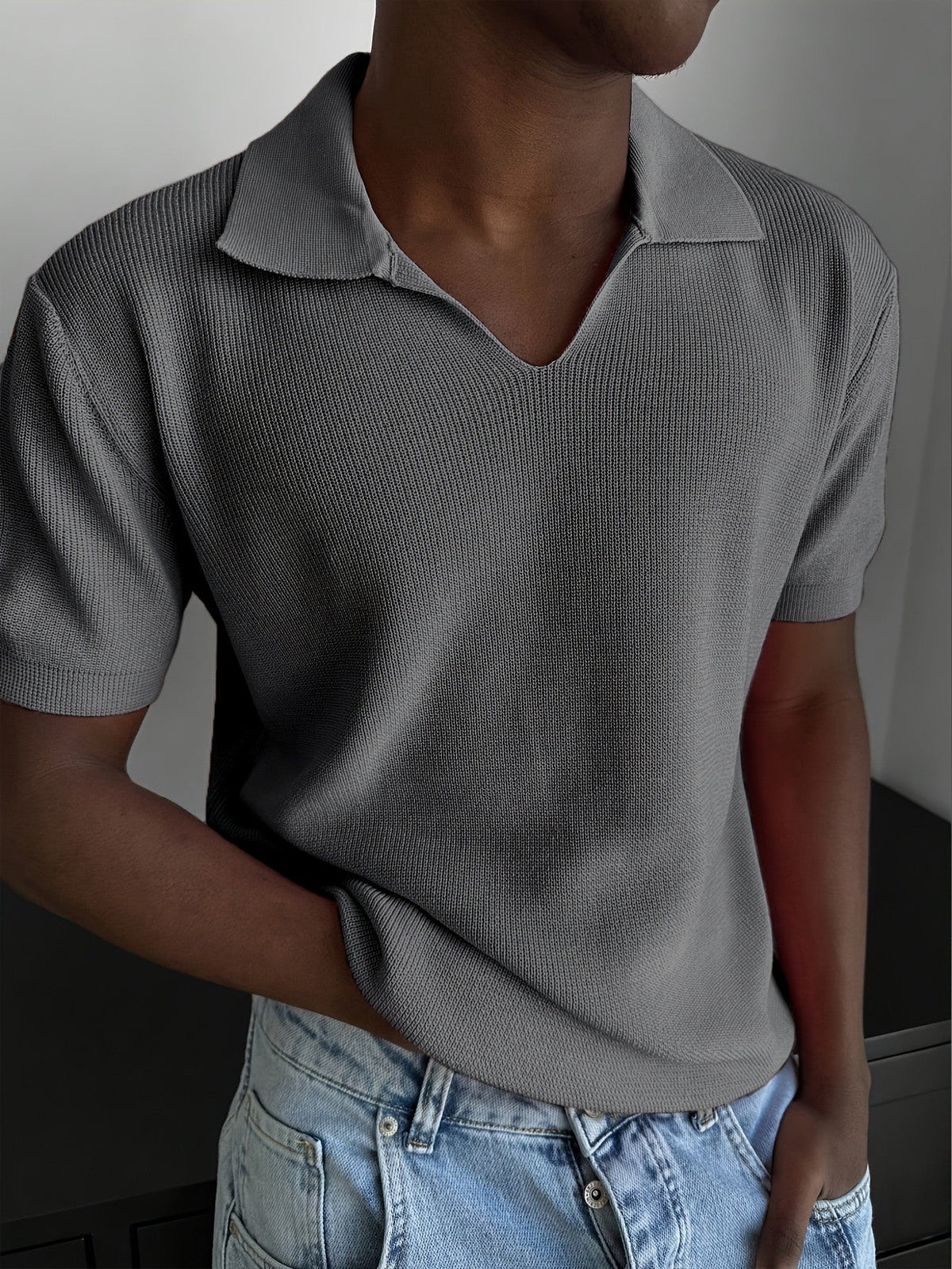 Men's polo shirt neckline showing the open V-neck design