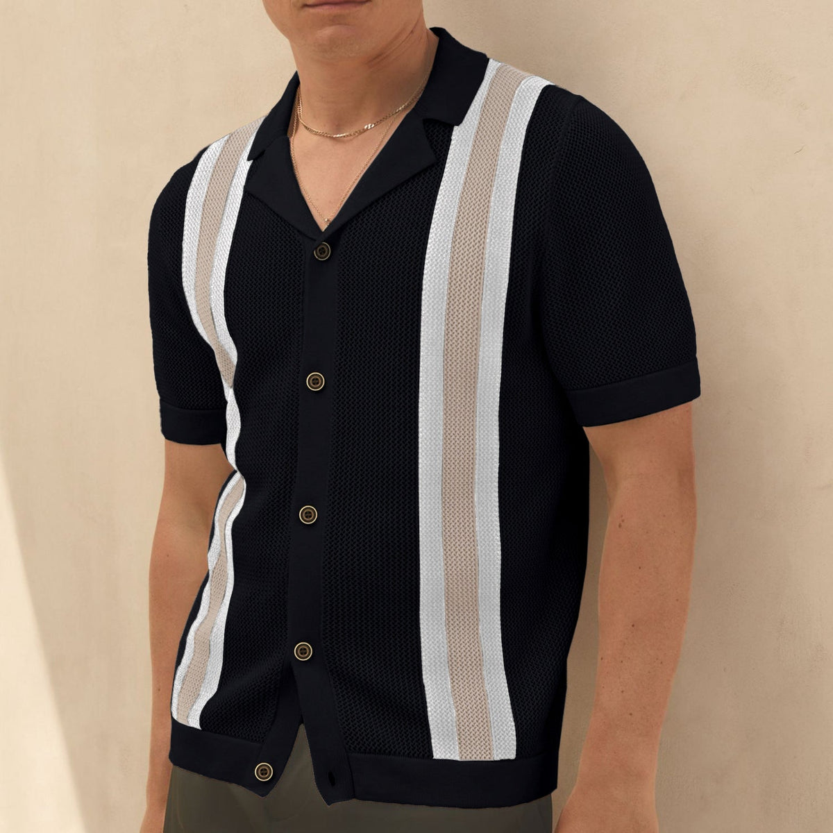 Close-up of the knitted texture and color block design on a men's cardigan