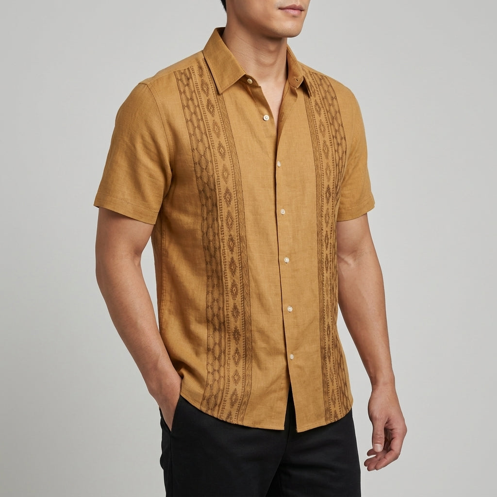Close-up of the green embroidered detail on the men's shirt