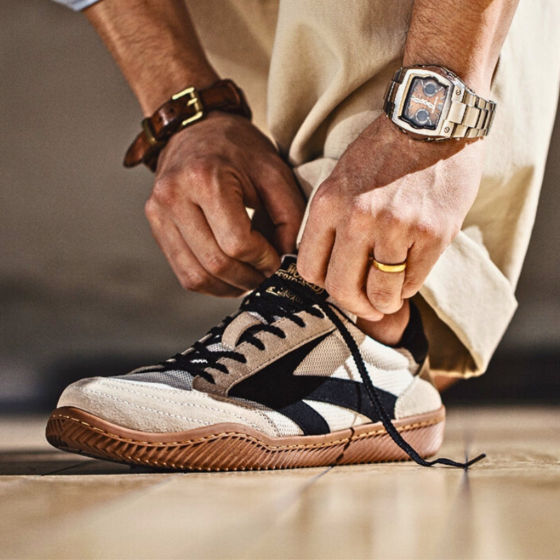 Pair of men's suede sneakers shown from the side
