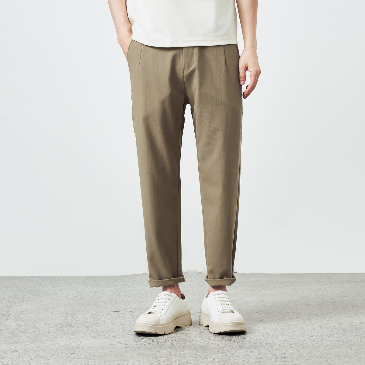 Men's khaki brown pants with pleated front and tapered legs