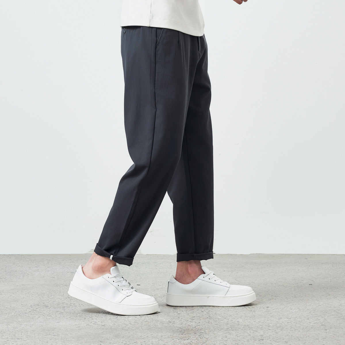 Detail of the waistband and side pockets on khaki brown pants