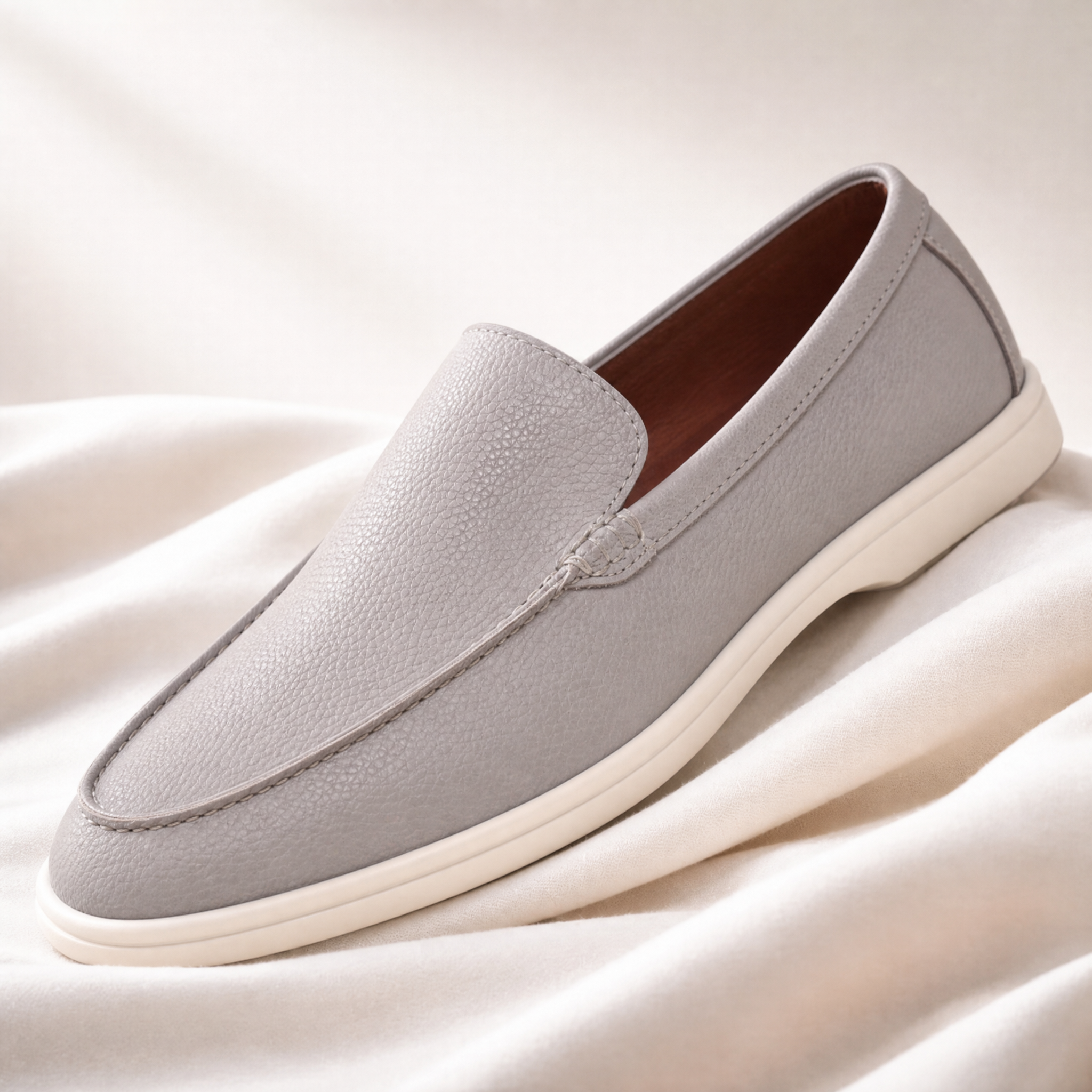 Pair of men's leather loafers displayed at an angle