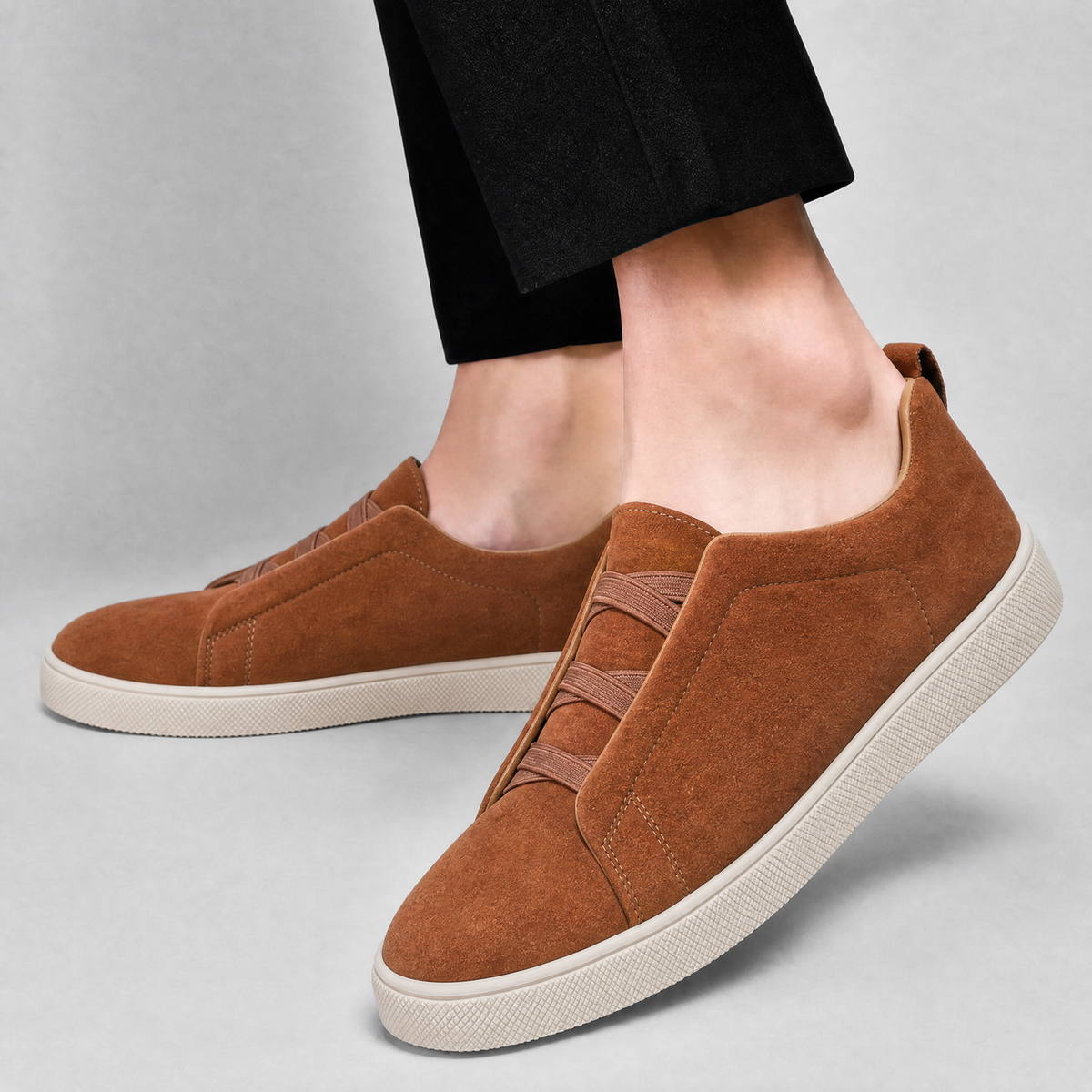 Pair of men's suede sneakers with flexible stretch laces