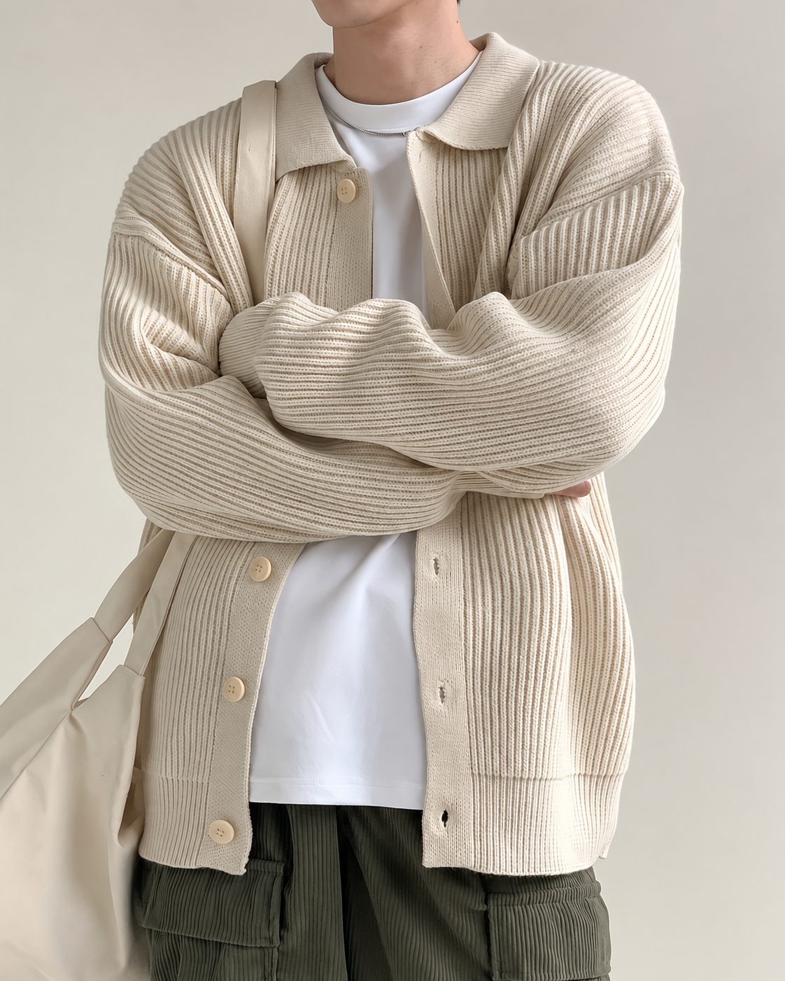 Detail view of the cardigan collar, buttons, and knit construction