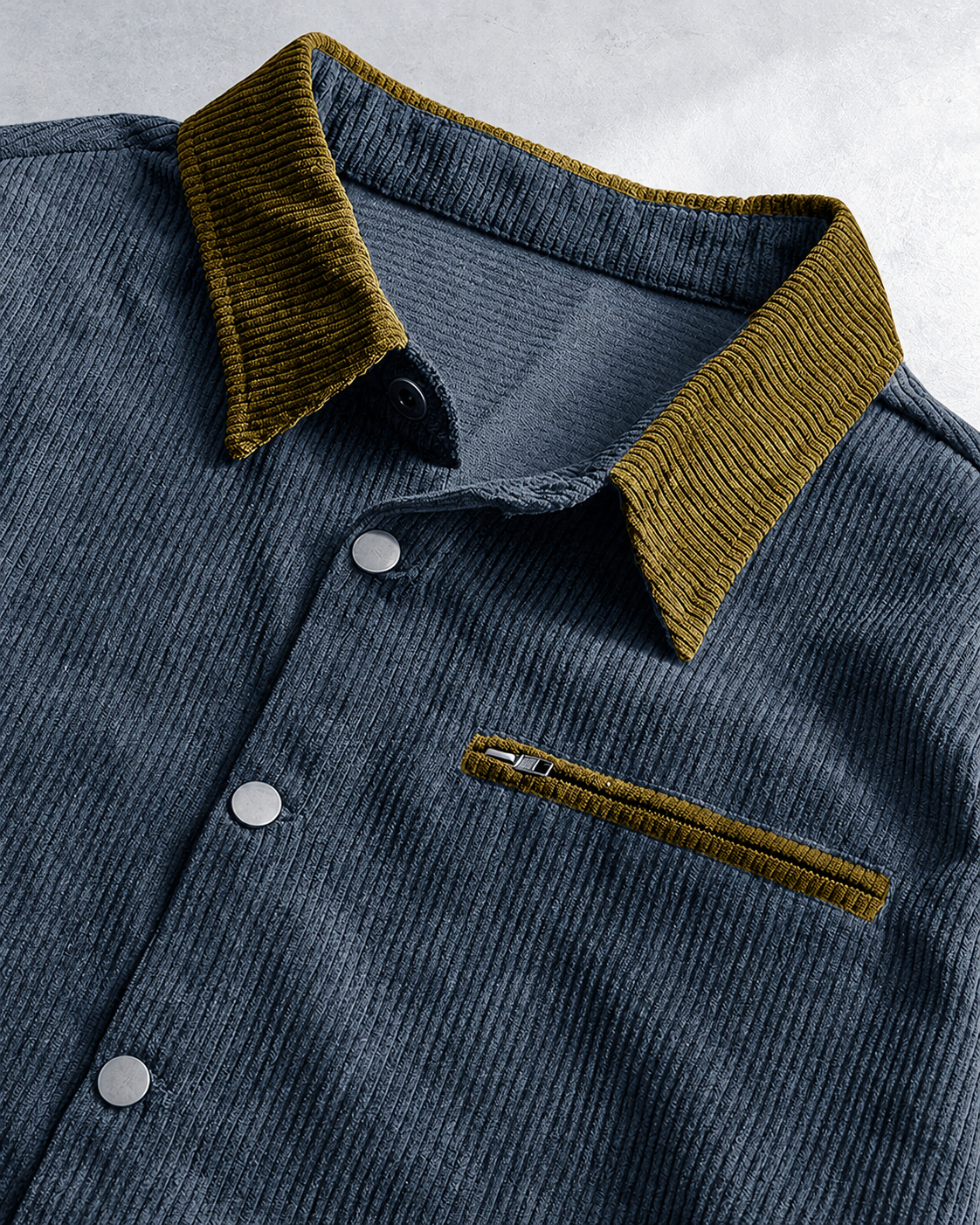 Detail view of the button front on a men's corduroy shirt jacket.