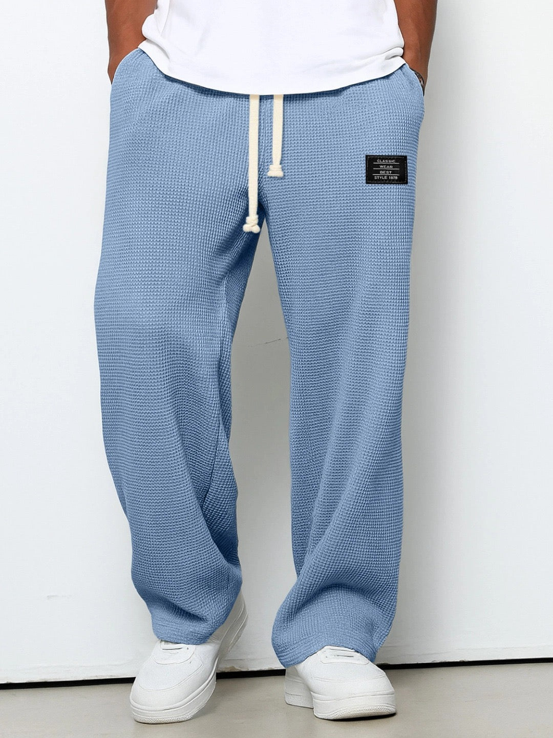 Relaxed men's pants shown with an adjustable drawstring waistband