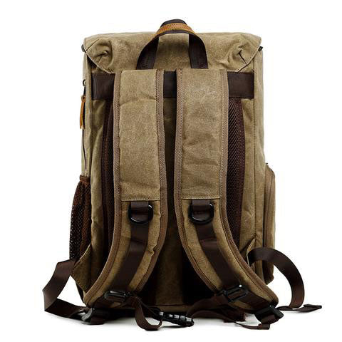 Open vintage camera backpack displaying organized interior storage for camera gear
