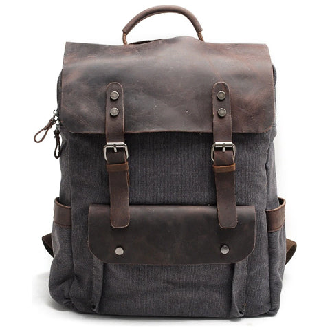 Vintage canvas leather backpack angled view with flap closure