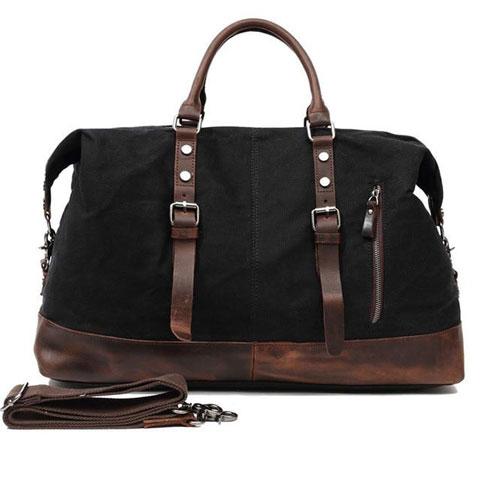 Vintage leather weekend bag with detachable shoulder strap displayed flat