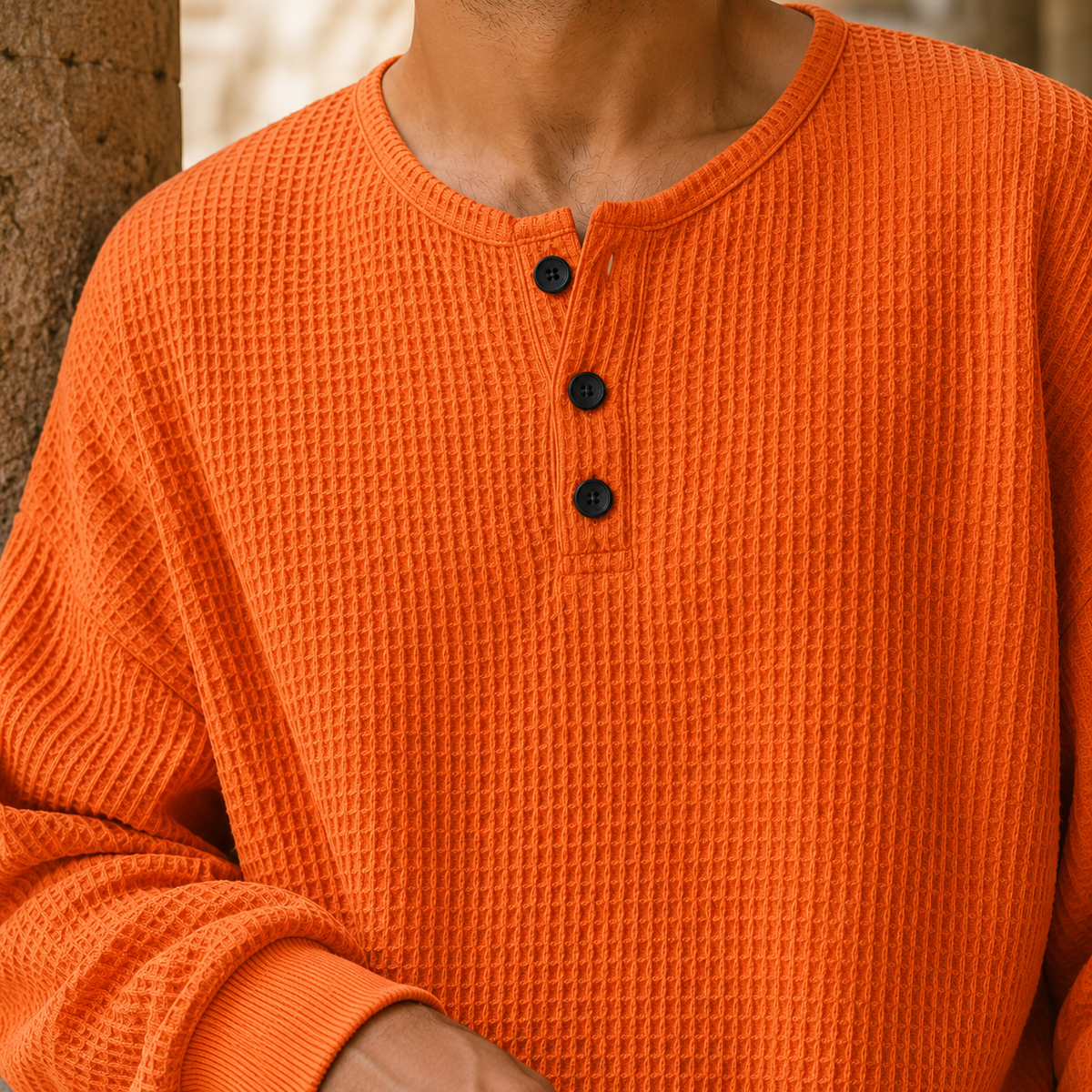 Close-up view of the waffle knit texture on a men's Henley sweater