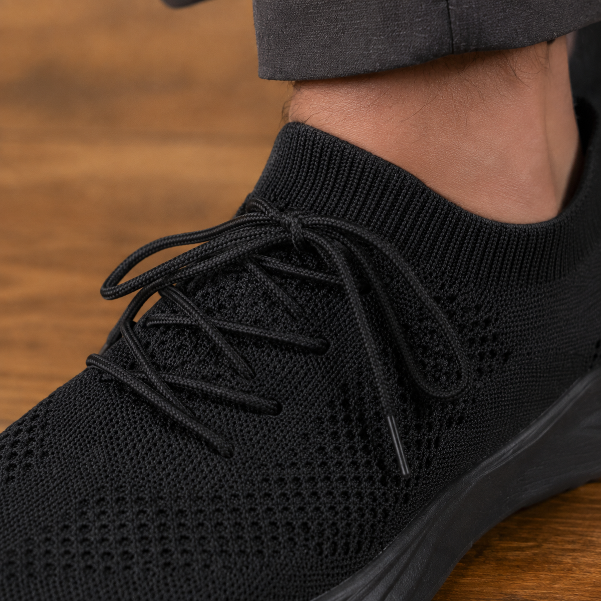 Close-up of the knit upper and lace-up details on men's casual sneakers