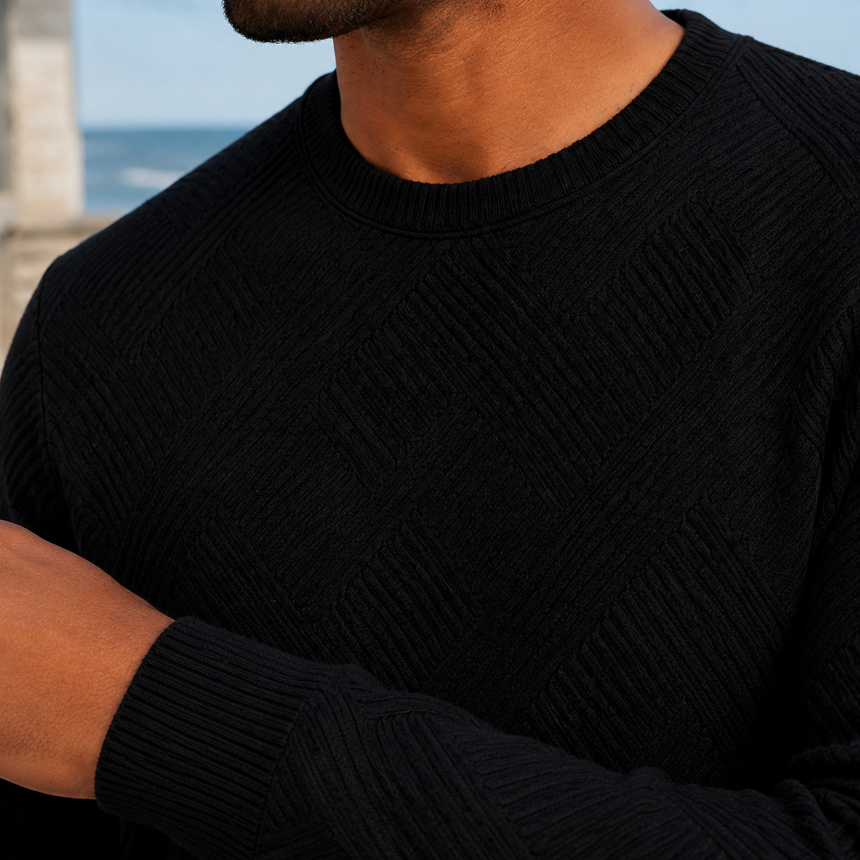 Men's crewneck sweater showing the neckline and long sleeves