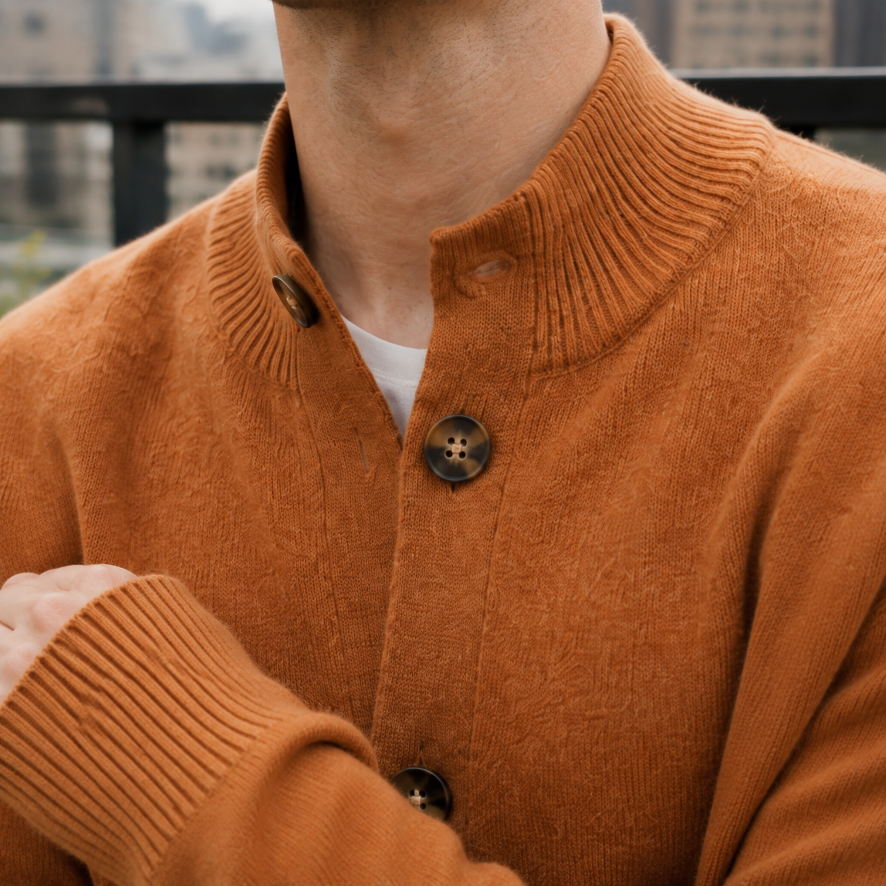 Close-up of the button-front detail on a men's cashmere blend sweater