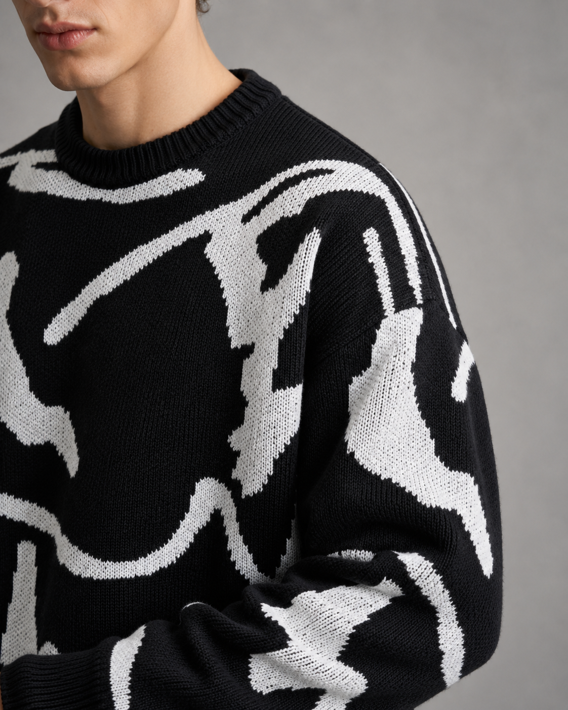 Close-up of the abstract graphic design on a men's knit sweater.