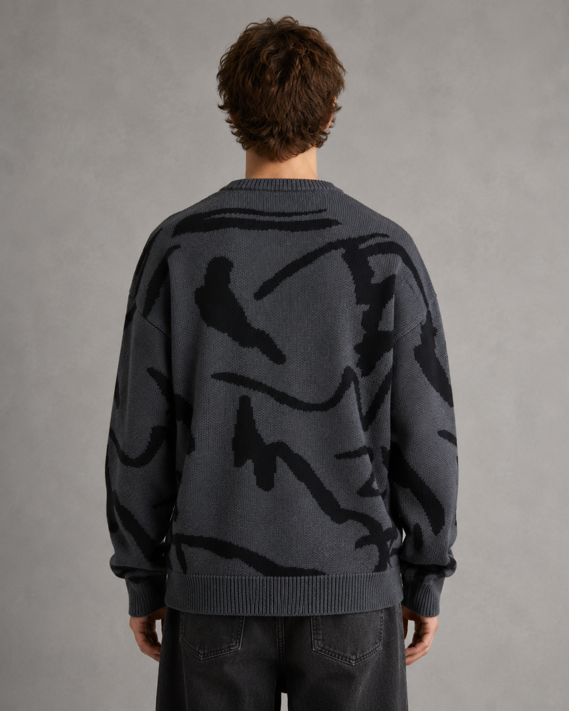 Side view of the men's abstract graphic sweater with a relaxed silhouette.
