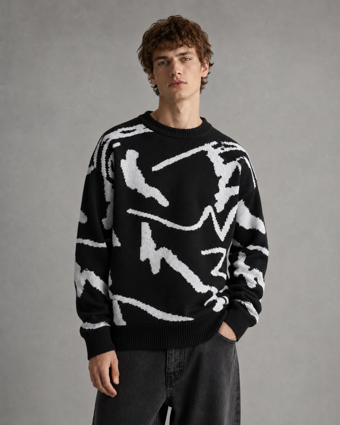 Men's abstract graphic knit sweater displayed from the back with drop shoulders.