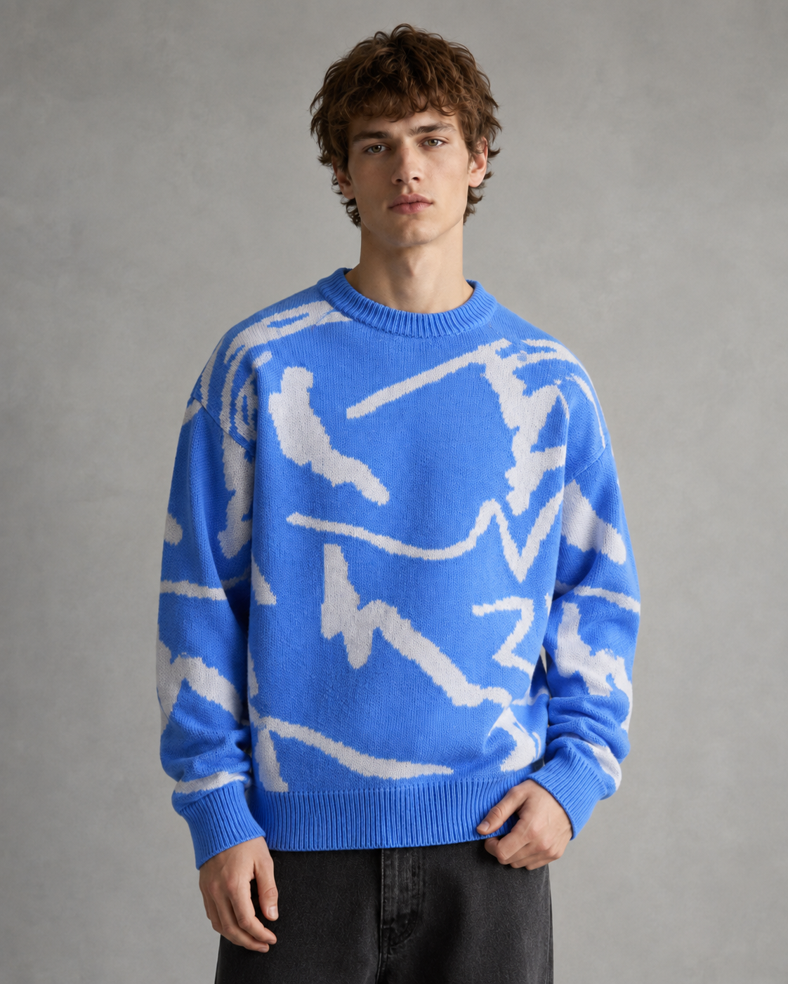 Men's abstract graphic knit sweater shown from the front in a relaxed fit.