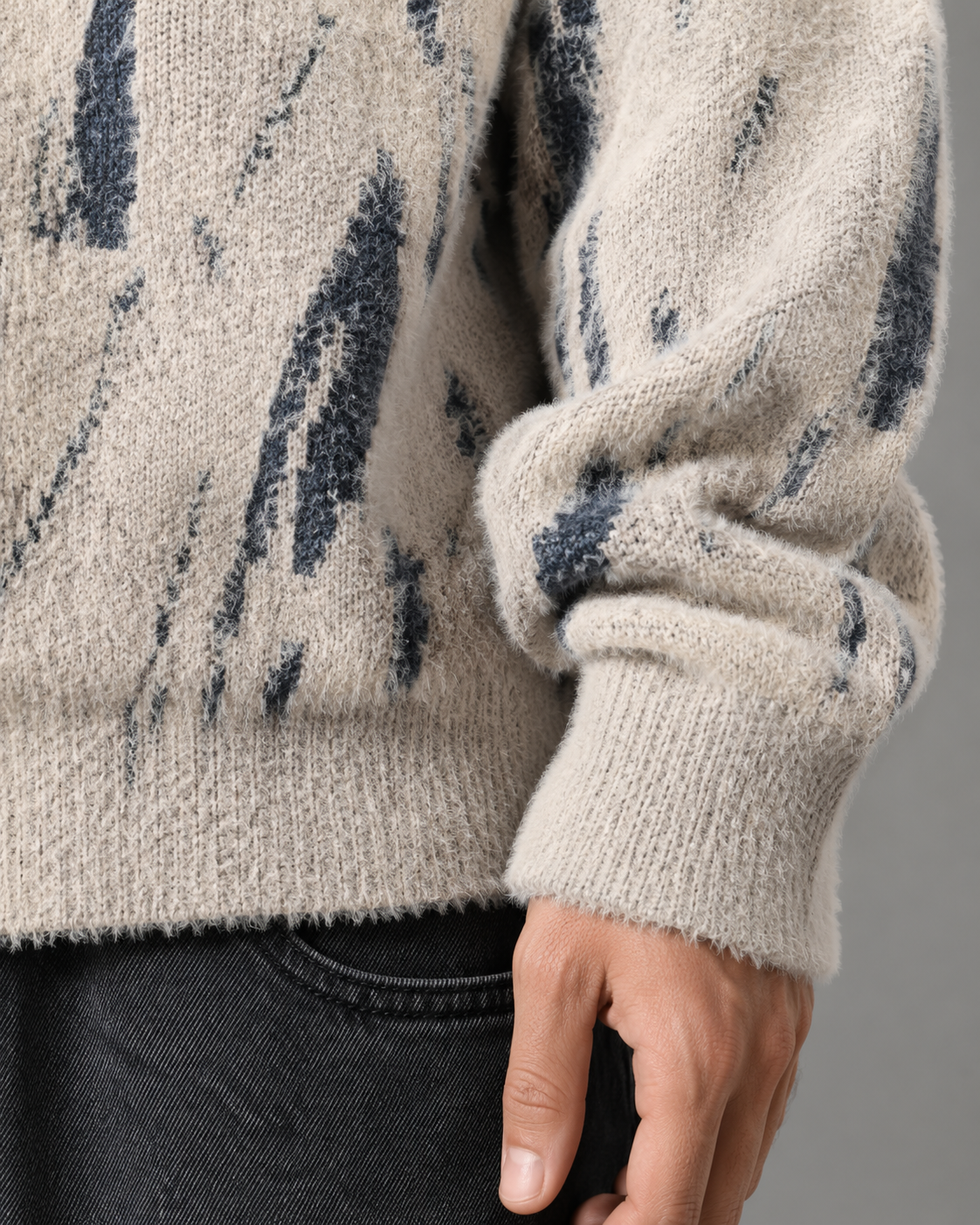 Detail of the sweater's abstract knitted pattern