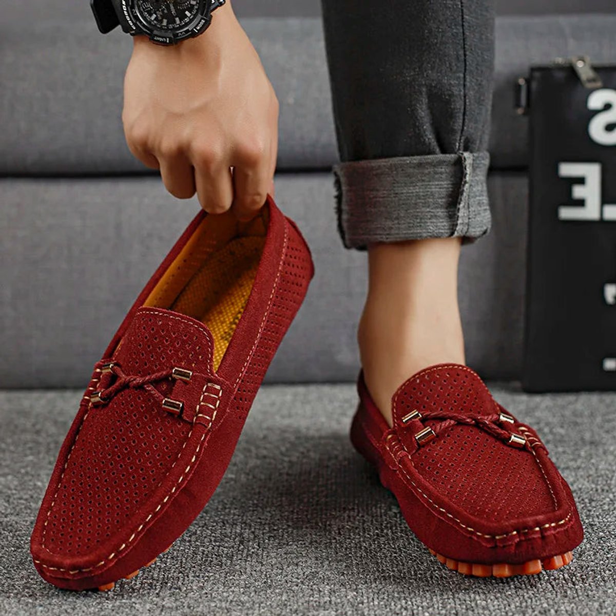 Close-up view of the perforated suede upper on a men's loafer