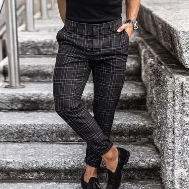 Men's plaid tapered pants displayed from the back