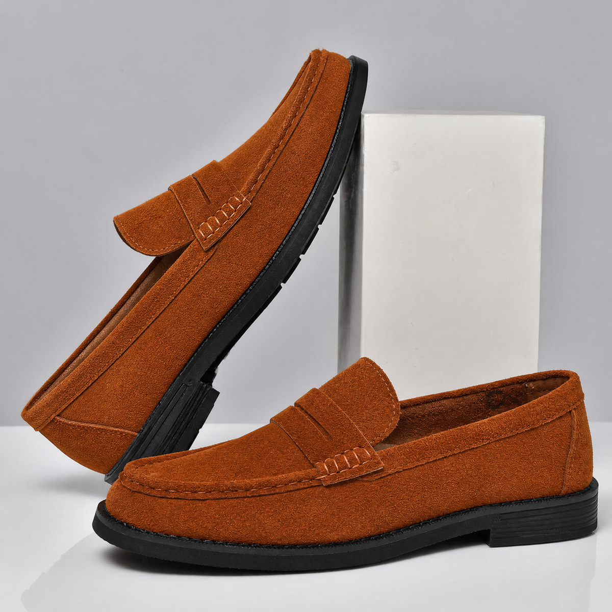 Pair of men's suede penny loafers viewed from above