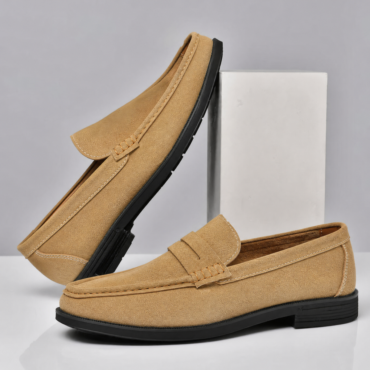 Men's suede penny loafers styled as versatile dress shoes
