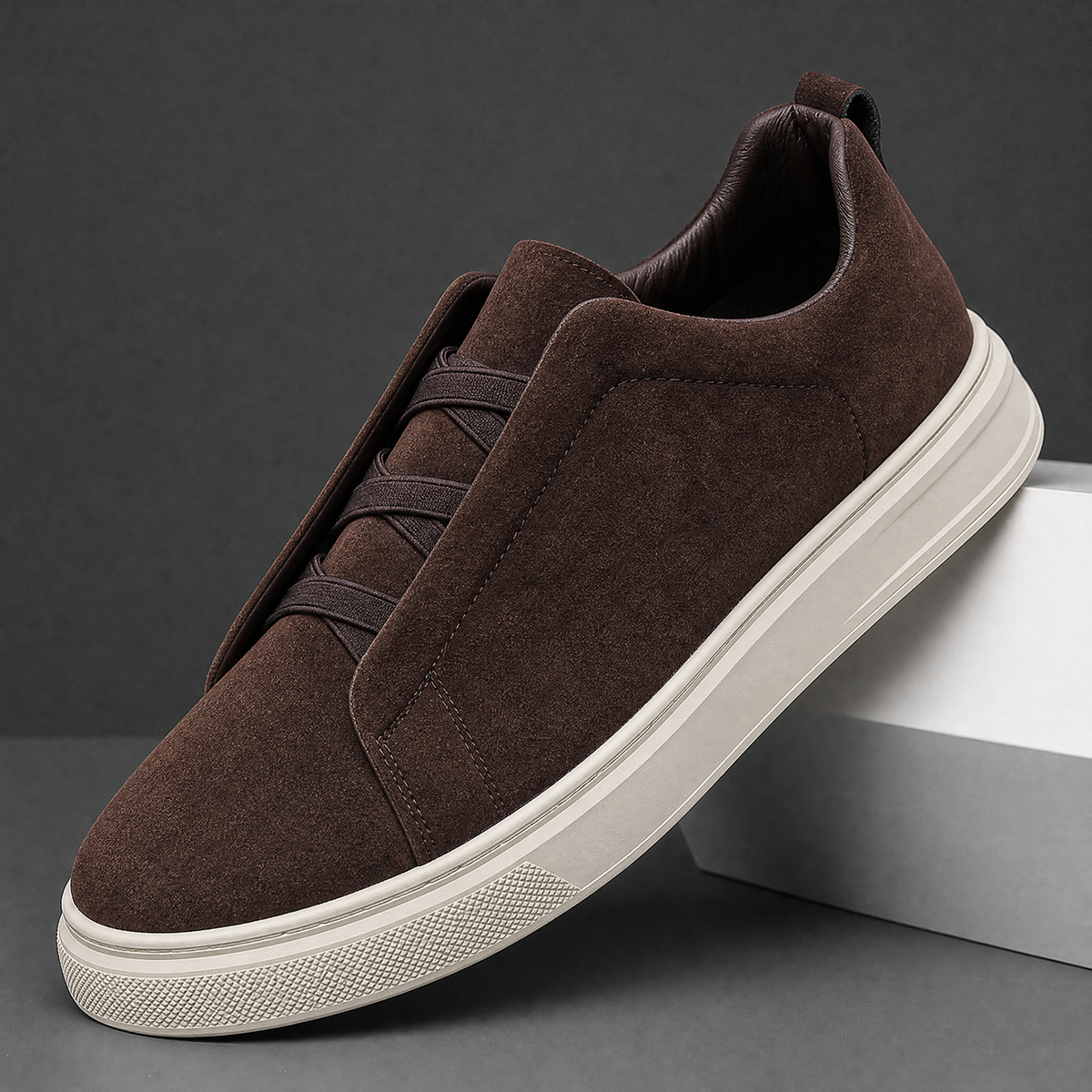 Men's casual suede sneaker displaying its lace-free slip-on design