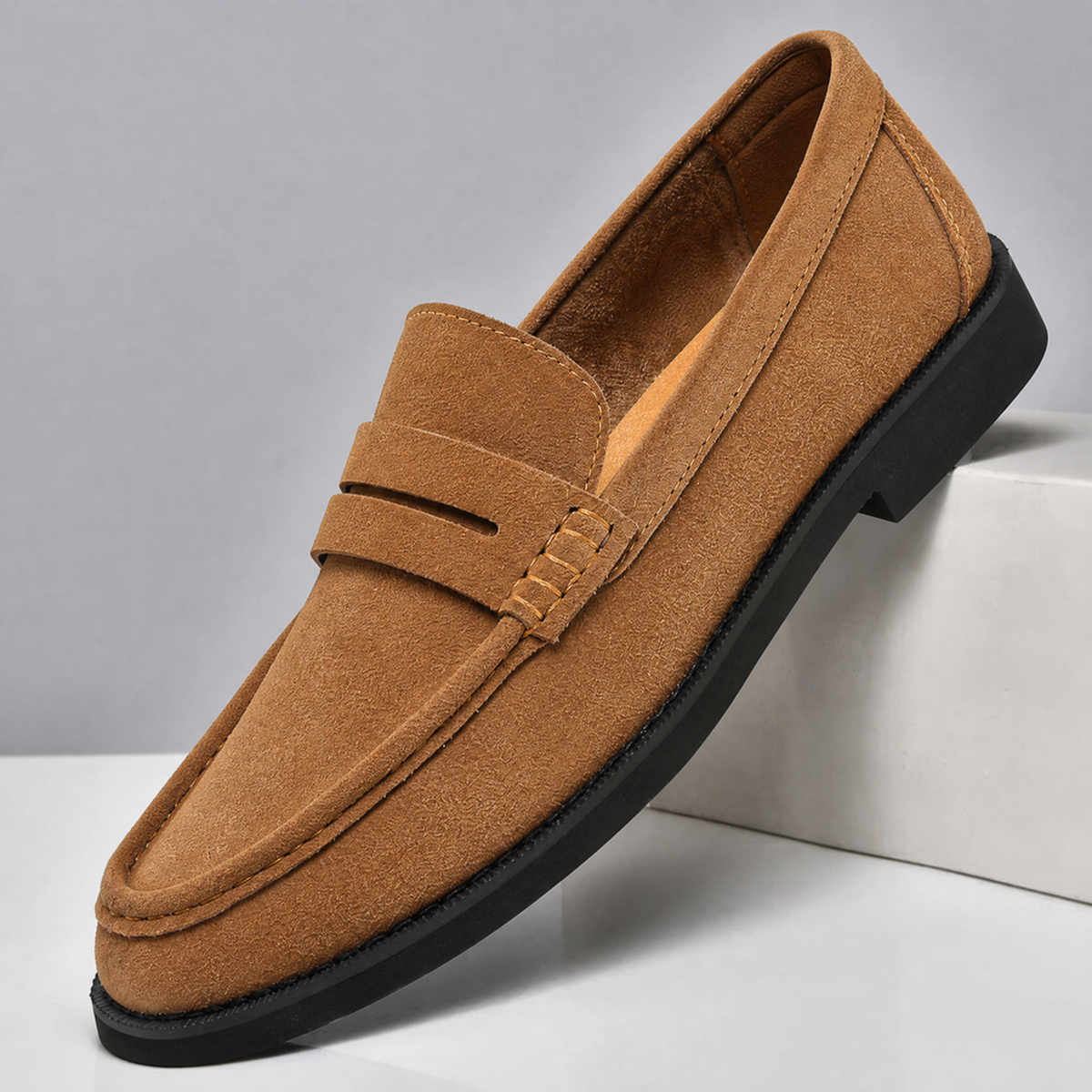 Men's suede penny loafers showing the slip-on design